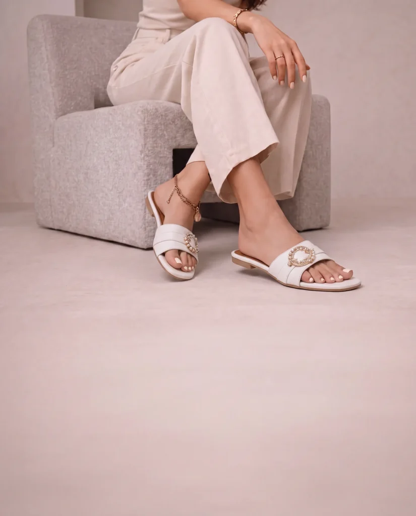 Woman wearing white sandals